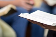 Diverse group of teens studying the Bible.